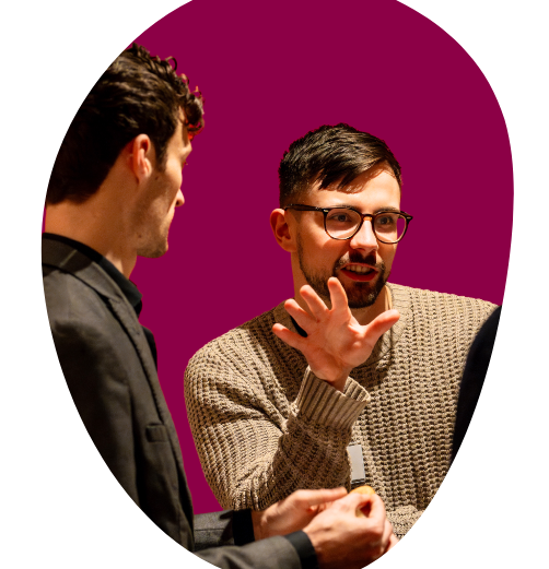 Three professionals discussing pharmaceutical market access consultancy strategy in a meeting setting.